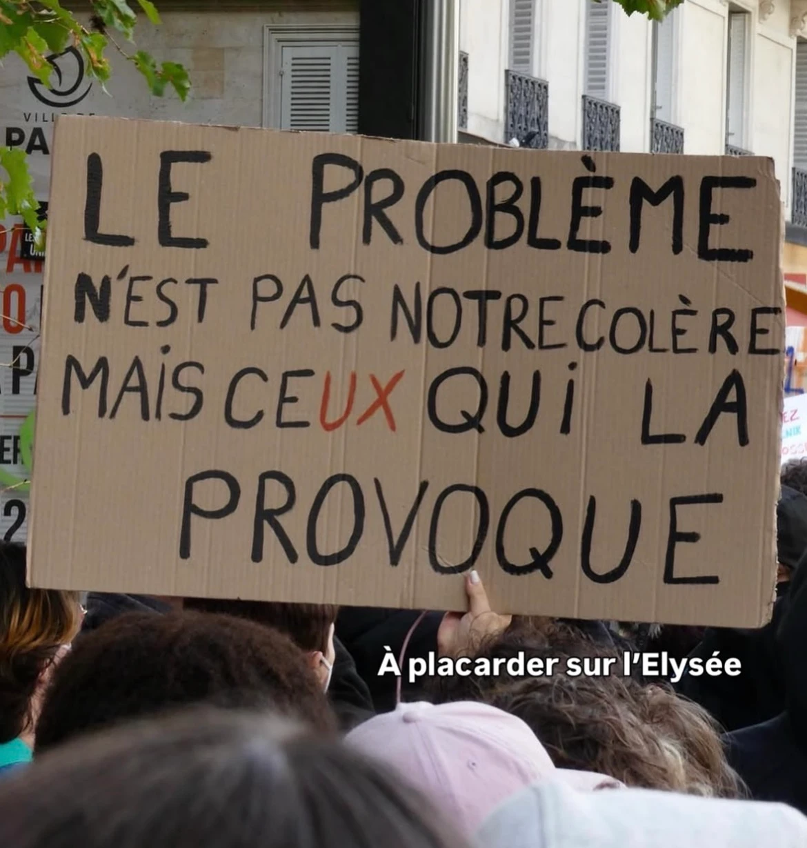 Protest sign reading: LE PROBLÈME N’EST PAS NOTRE COLÈRE MAIS CEUX QUI LA PROVOQUE